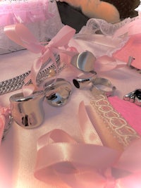 a bunch of pink and silver jewelry on a table