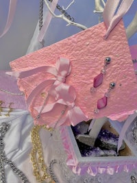 a pink box with a necklace and earrings on it